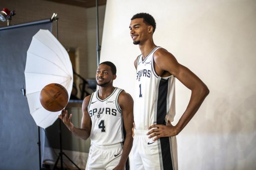 French basketball player Victor Wembanyama (R) and US player De'Aaron Fox (L) pose for promotional photos during the San Antonio Spurs media day at the Victory Capital Performance Center in San Antonio, Texas on September 29, 2025. Wembanyama has been cleared by the team's medical staff to play for the upcoming season. SERGIO FLORES / AFP