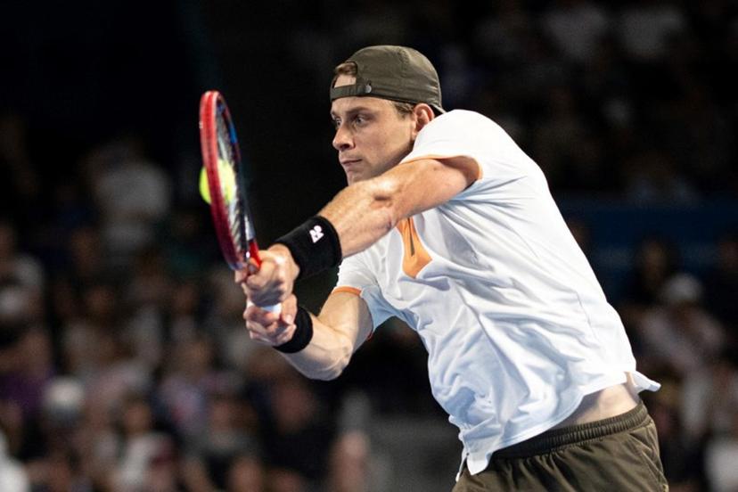 Belgium's Zizou Bergs hits a return against Spain's Carlos Alcaraz during their men's singles match at the ATP Japan Open tennis tournament in Tokyo on September 27, 2025.  Philip FONG / AFP