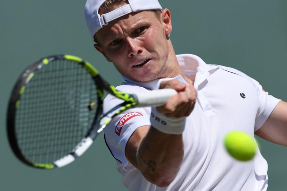 Netherlands' Jesper de Jong plays a forehand return to Serbia's Miomir Kecmanovic during their men's singles second round tennis match on the fourth day of the 2025 Wimbledon Championships at The All England Lawn Tennis and Croquet Club in Wimbledon, southwest London, on July 3, 2025.   Adrian Dennis / AFP