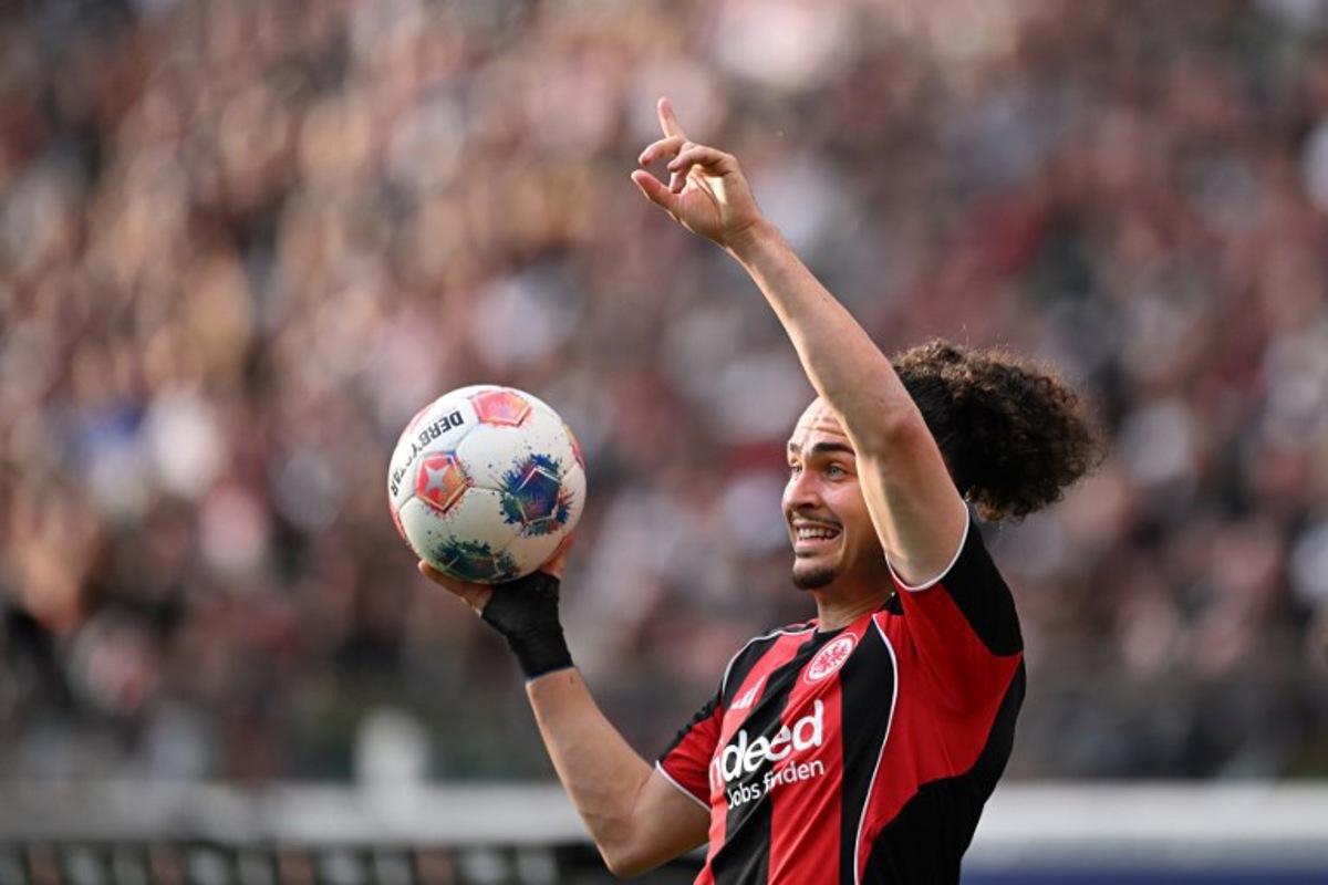 Frankfurt's Belgian defender #03 Arthur Theate gestures with the ball during the German first division Bundesliga football match between Eintracht Frankfurt and RB Leipzig in Frankfurt am Main, western Germany, on April 18, 2026.  Kirill KUDRYAVTSEV / AFP