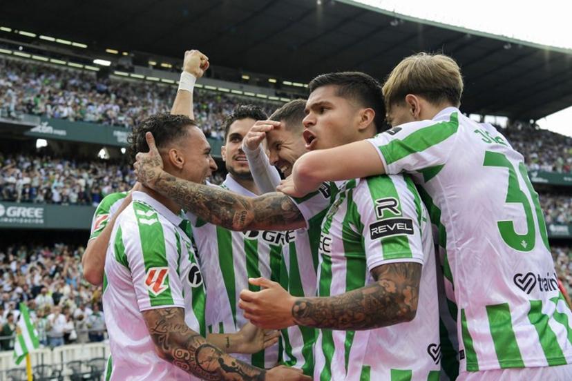 Real Betis' players celebrate after scoring their first goal during the Spanish league football match between Real Betis and Villarreal CF at the Benito Villamarin stadium in Seville on April 13, 2025.  CRISTINA QUICLER / AFP