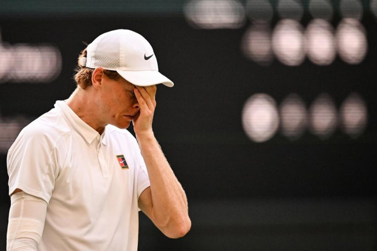 Italy's Jannik Sinner celebrates after victory against Spain's Carlos Alcaraz at the end of their men's singles final tennis match on the fourteenth day of the 2025 Wimbledon Championships at The All England Lawn Tennis and Croquet Club in Wimbledon, southwest London, on July 13, 2025.  Kirill KUDRYAVTSEV / AFP