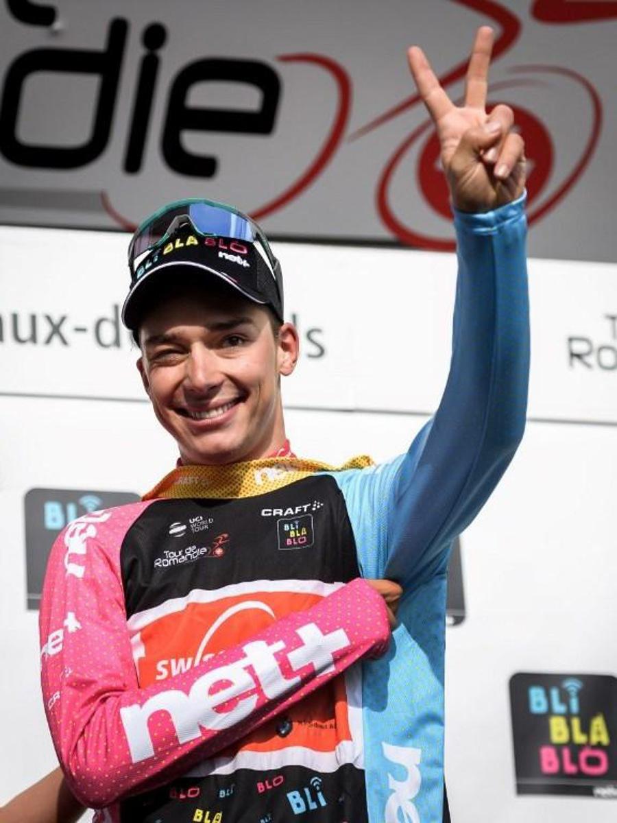 Switzerland's Simon Pellaud celebrates on the podium after winning the best climber's jersey during the 1st stage, 168,4 km from Neuchatel to La Chaux-de-Fonds, of the Tour de Romandie UCI World Tour 2019 cycling race, on May 1, 2019 in La Chaux-de-Fonds.  Fabrice COFFRINI / AFP