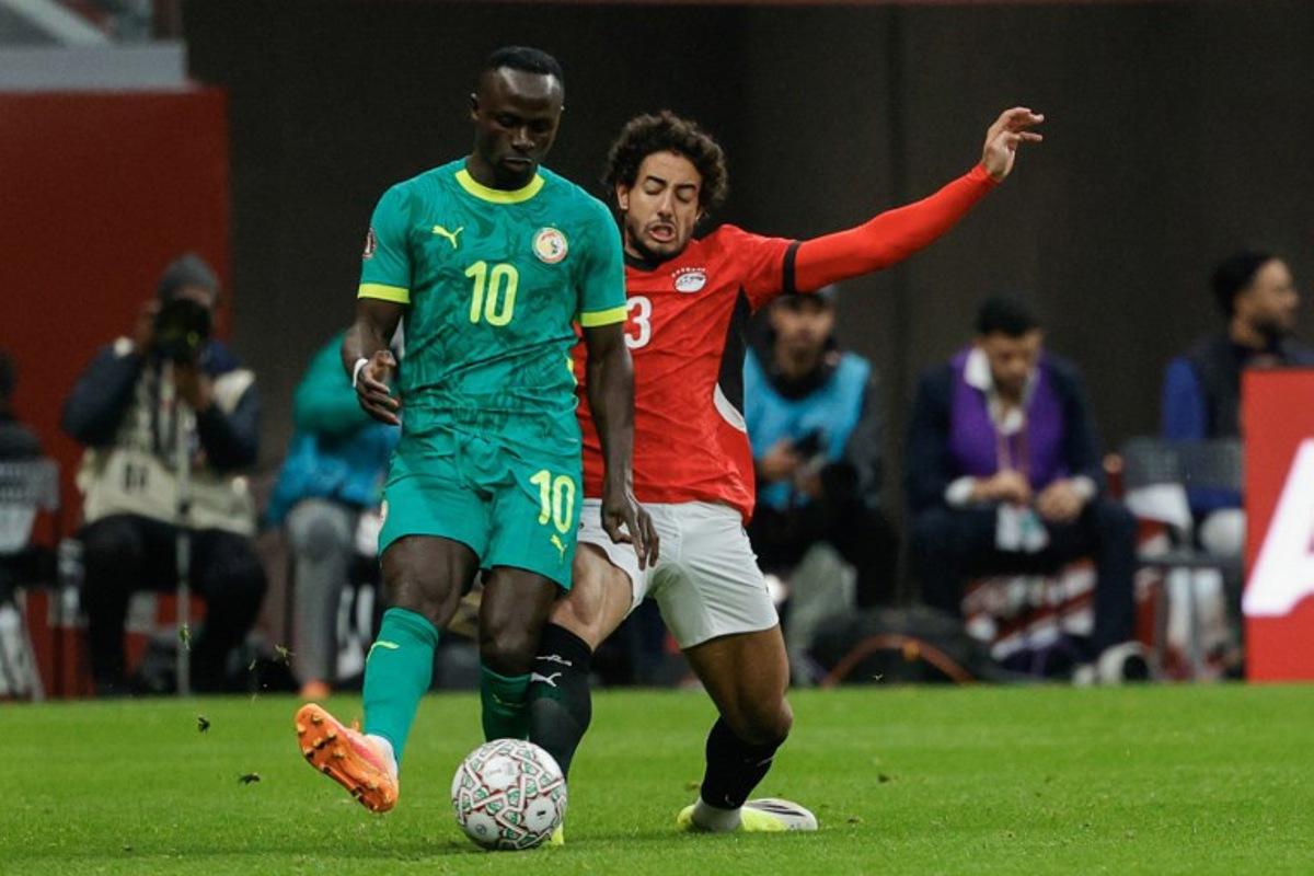 Senegal's forward #10 Sadio Mane and Egypt's defender #3 Mohamed Hany vie during the Africa Cup of Nations (CAN) semi-final football match between Senegal and Egypt at the Grand stadium in Tangiers on January 14, 2026.   Abdel Majid BZIOUAT / AFP