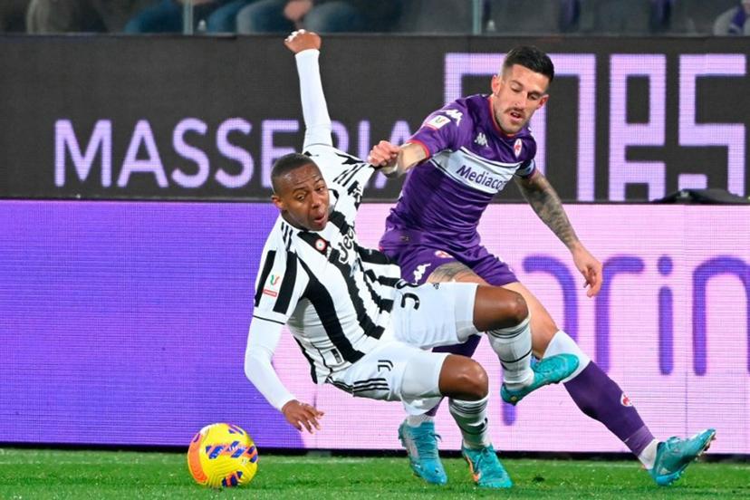 Juventus' midfielder Franch Marley Ake (L) is challenged by Fiorentina's Italian defender Cristiano Biraghi during the Italian Cup (Coppa Italia) semi-final first leg football match Fiorentina vs Juventus at the Artemio-Franchi stadium in Florence on March 2, 2022.  Alberto PIZZOLI / AFP