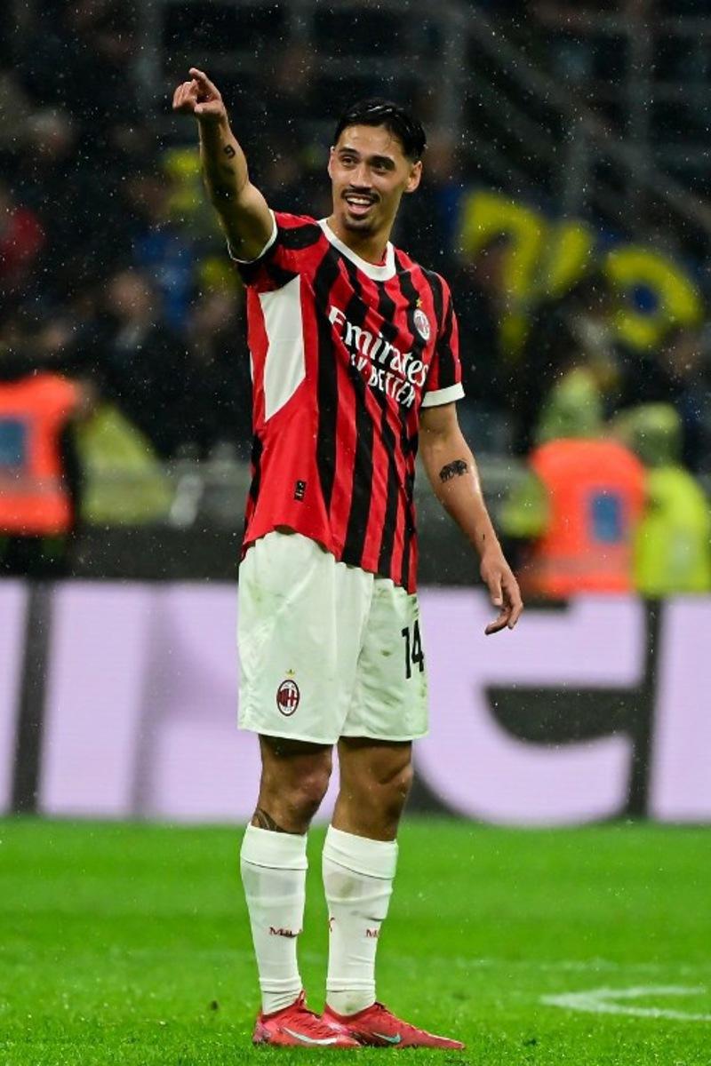 AC Milan's Dutch midfielder #14 Tijani Reijnders celebrates after scoring AC Milan's third goal  during the Coppa Italia second leg semi-final football match between Inter Milan and AC Milan at the San Siro stadium in Milan on April 23, 2025.  Piero CRUCIATTI / AFP