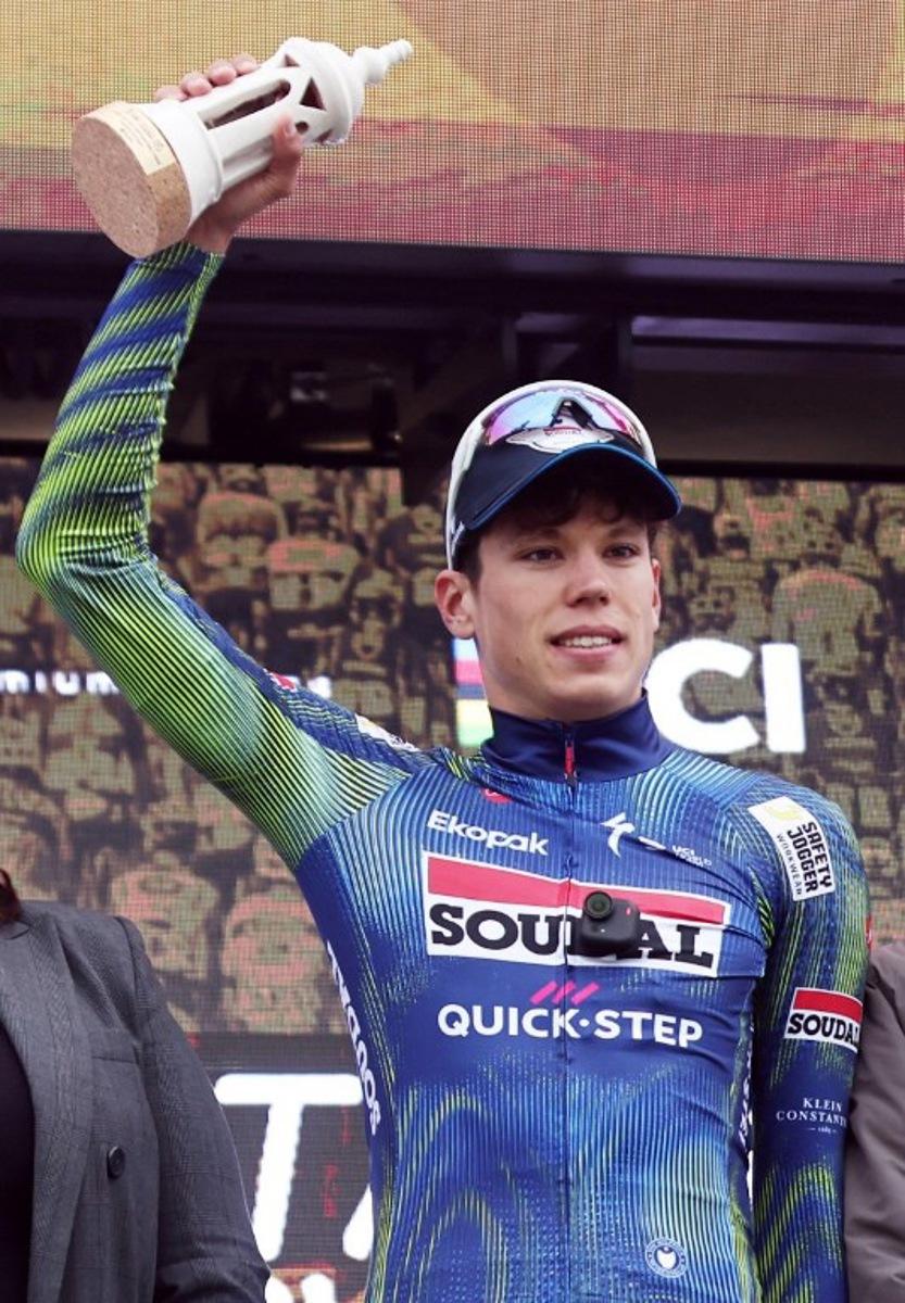 Soudal Quick-Step French cyclist Paul Magnier celebrates on the podium after winning the first stage of the 52nd edition of the Volta ao Algarve, a 183.5 km race between Vila Real de Santo Antonio and Tavira, on February 18, 2026.  João Matos / AFP