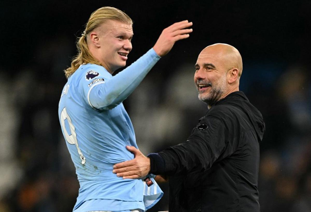 Manchester City's Norwegian striker #09 Erling Haaland (L) reacts with Manchester City's Spanish manager Pep Guardiola after the English Premier League football match between Manchester City and Leeds United at the Etihad Stadium in Manchester, north west England, on November 29, 2025.  Oli SCARFF / AFP