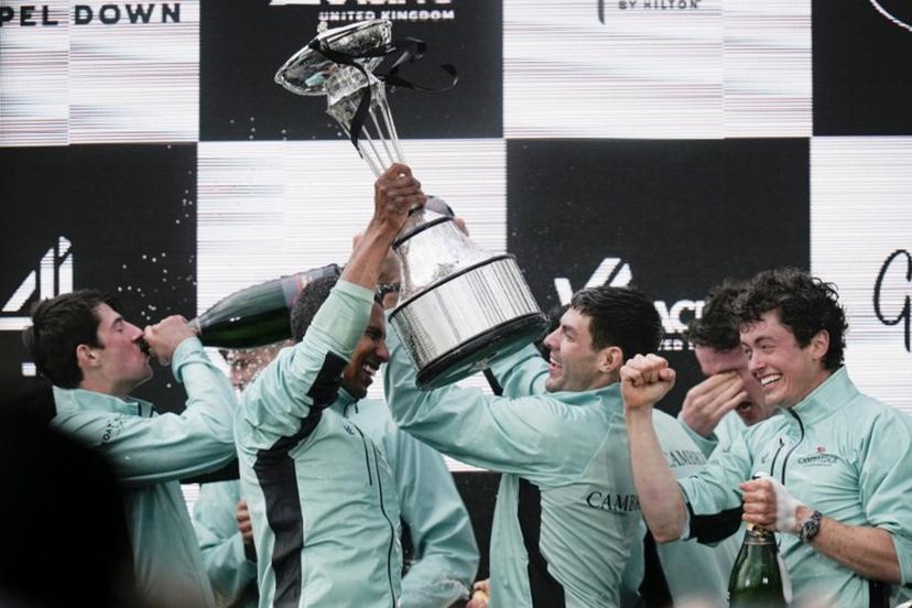 Cambridge's French president, Noam Mouelle celebrates lifts the trophy after winning the 171th men's boat race between Oxford University and Cambridge University on the River Thames in London on April 4, 2026.    CARLOS JASSO / AFP