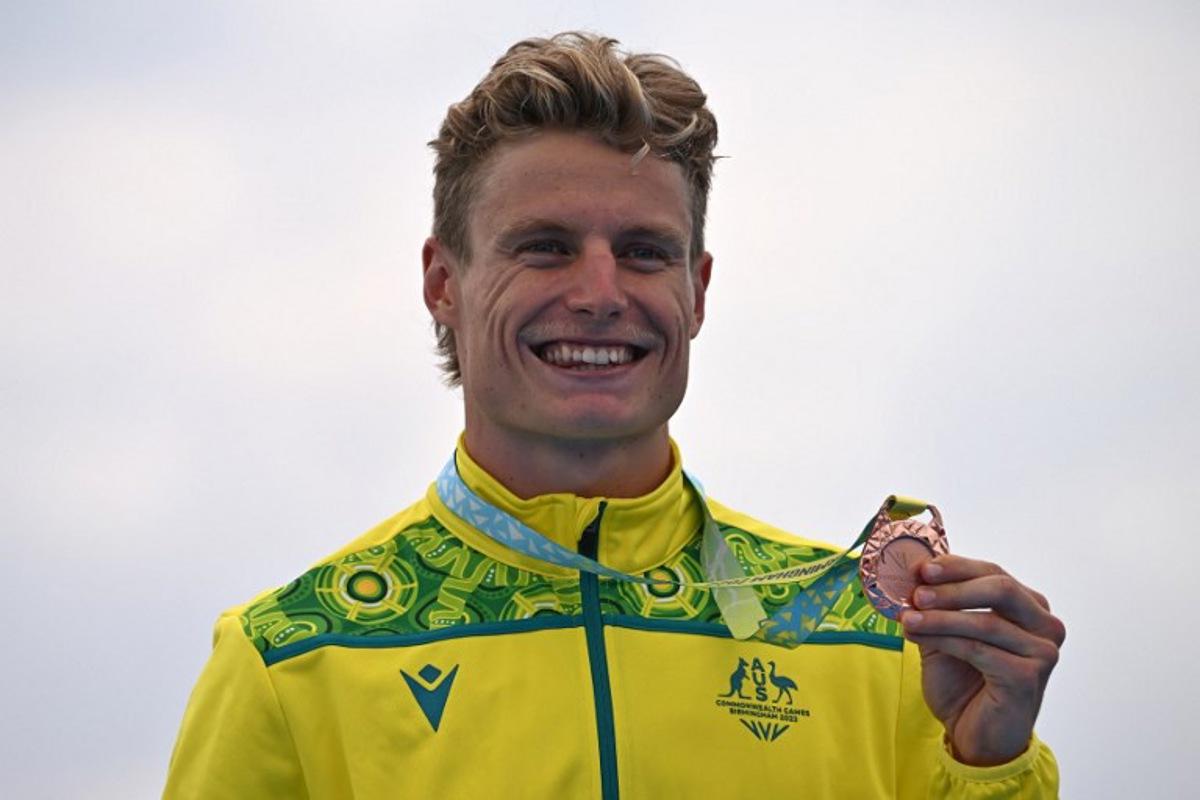 Bronze medallist Australia's Matthew Hauser poses with his medal during the medal presentation ceremony for the Men's Individual Sprint Distance Triathlon event on day one of the Commonwealth Games at Sutton Park in Sutton Coldfield, central England, on July 29, 2022.  Ben Stansall / AFP