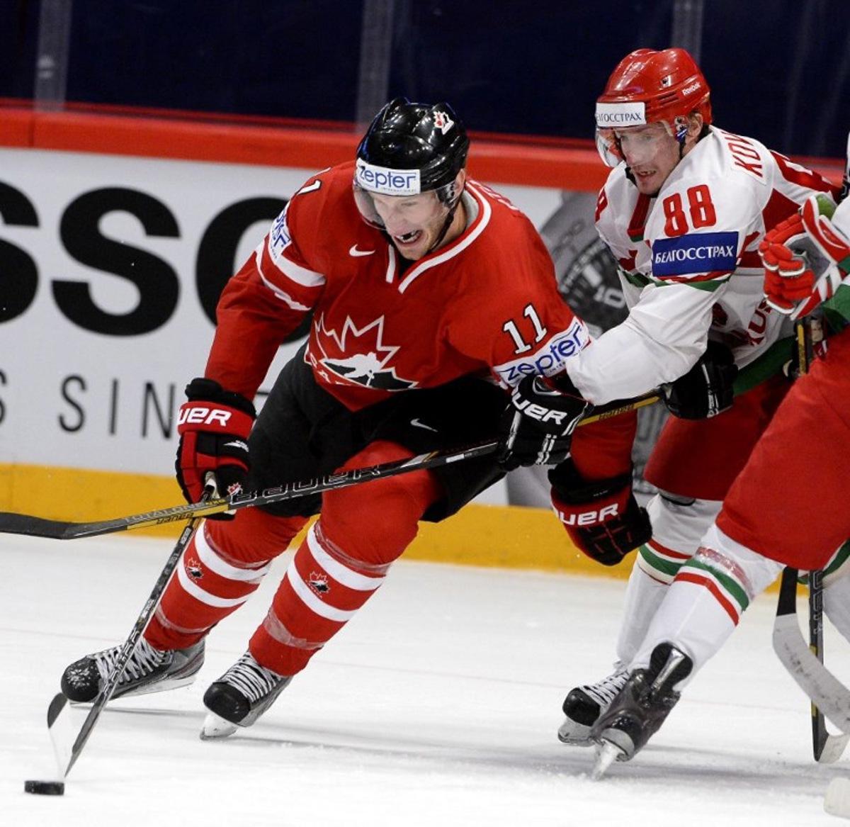 Belarus' Yevgeni Kovyrshin (R) and Canada's Jordan Staal vie for the puck during the preliminary round match Belarus vs Canada at the 2013 IIHF Ice Hockey World Championships on May 10, 2013 in Stockholm. AFP PHOTO/JONATHAN NACKSTRAND JONATHAN NACKSTRAND / AFP