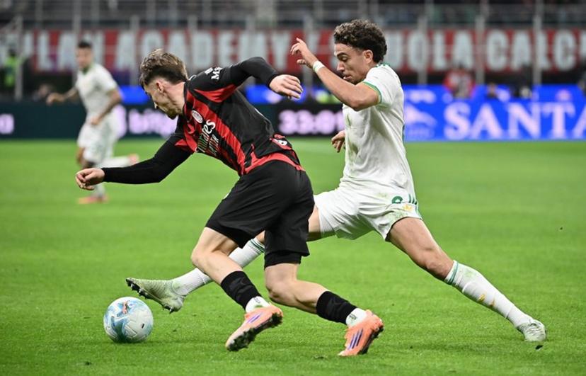 Roma's French midfielder #08 Neil El Aynaoui (R) fights for the ball with AC Milan's Begian midfielder #56 Alexis Saelemaekers during the Italian Serie A football match between AC Milan and AS Roma at San Siro stadium in Milan, on November 2, 2025.  Isabella BONOTTO / AFP