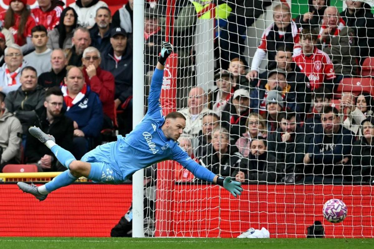Nottingham Forest's Belgian goalkeeper #26 Matz Sels reaches to save a shot during the English Premier League football match between Nottingham Forest and Chelsea  at The City Ground in Nottingham, central England, on October 18, 2025.  JUSTIN TALLIS / AFP