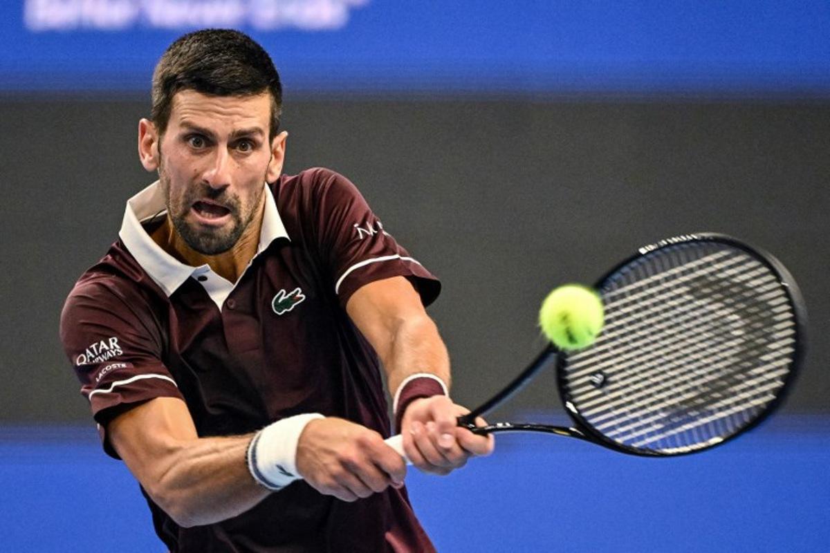 Serbia's Novak Djokovic hits a return to Australia's Alex de Minaur during the men's singles final at the China Open tennis tournament in Beijing on October 6, 2026  GREG BAKER / AFP