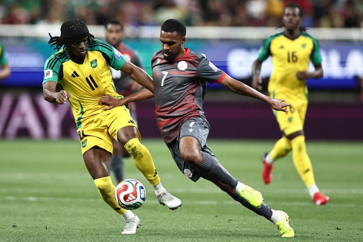 Jamaica's forward #11 Tyreece Campbell and New Caledonia's midfielder #07 Jekob Jeno fight for the ball during the 2026 FIFA World Cup qualifiers semi-final playoff football match between New Caledonia and Jamaica at the Akron Stadium in Zapopan, Mexico on March 26, 2026.  Ulises Ruiz / AFP
