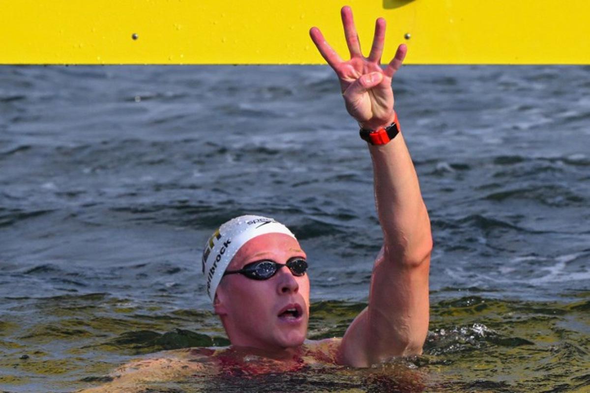 Germany's swimmer Florian Wellbrock celebrates after winning the final of the mixed 4x1500m relay open water swimming event during the 2025 World Aquatics Championships at Sentosa Island in Singapore on July 20, 2025.  François-Xavier MARIT / AFP
