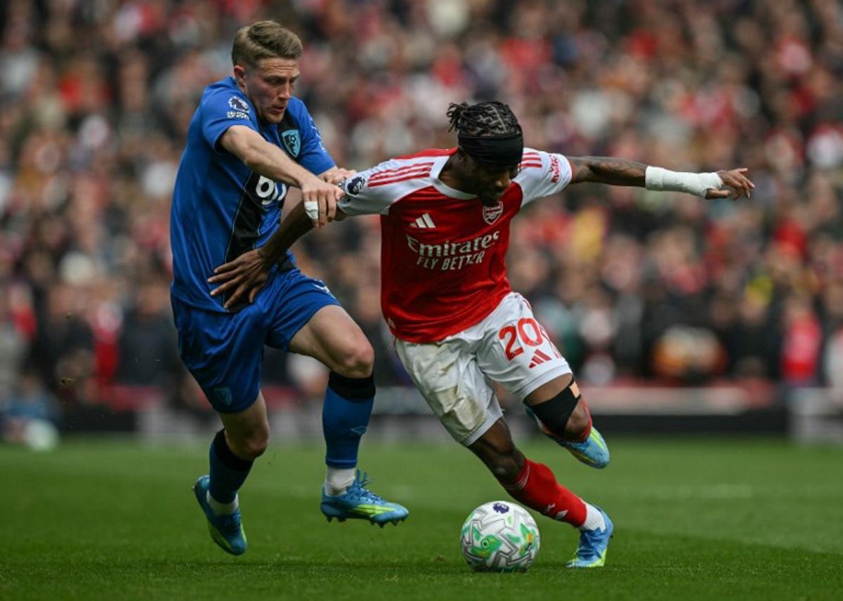 Bournemouth's French defender #03 Adrien Truffert (L) tackles Arsenal's English midfielder #20 Noni Madueke (R) during the English Premier League football match between Arsenal and Bournemouth at the Emirates Stadium in London on April 11, 2026.   Glyn KIRK / AFP