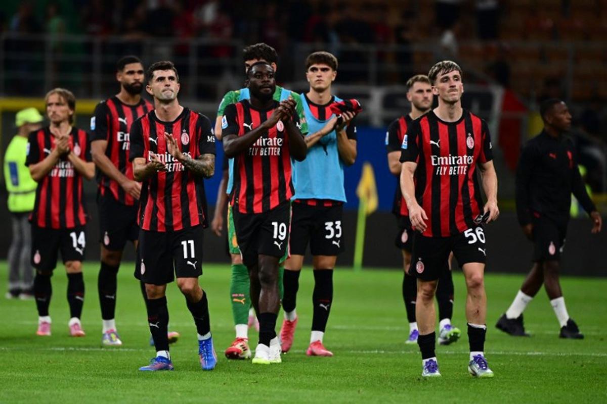 AC Milan's Croatian midfielder #14 Luka Modric, AC Milan's US forward #11 Christian Pulisic, AC Milan's French midfielder #19 Youssouf Fofana, AC Milan's Italian defender #33 Davide Bartesaghi and AC Milan's Begian midfielder #56 Alexis Saelemaekers greet fans at the end of the Italian Serie A football match between AC Milan and Cremonese at San Siro stadium in Milan, on August 23, 2025.  PIERO CRUCIATTI / AFP