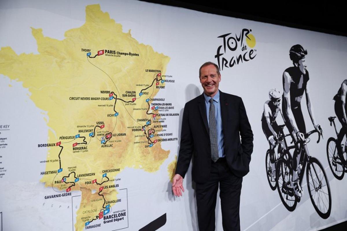 Tour de France General Director Christian Prudhomme poses for a picture in front of the map showing the women's route during the presentation of the official routes of the 2026 edition of the men's and women's Tour de France cycling race in Paris on October 23, 2025.   Anne-Christine POUJOULAT / AFP