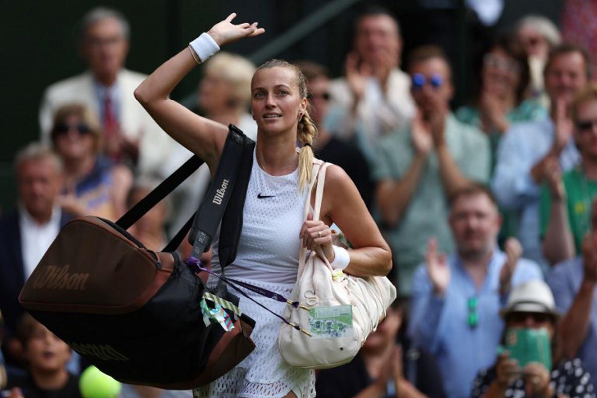 Czech Republic's Petra Kvitova waves as she leaves the court after being beaten by Tunisia's Ons Jabeur during their women's singles tennis match on the eighth day of the 2023 Wimbledon Championships at The All England Tennis Club in Wimbledon, southwest London, on July 10, 2023.   Adrian DENNIS / AFP