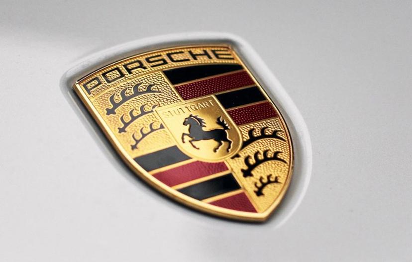 The logo of German car producer Porsche AG is pictured on the sidelines of the launch of the company's initial public offering (IPO) at the Frankfurt Stock Exchange in Frankfurt, western Germany, on September 29, 2022. Luxury sports carmaker Porsche will on September 29, 2022 race onto the Frankfurt stock exchange in what is set to be one of Europe's biggest listings in years, seeking to defy recent market turbulence. Parent company Volkswagen hopes the flotation will raise up to 9.4 billion euros (USD 9.2 billion) and are targeting a valuation of up to 75 billion euros for Porsche. Daniel ROLAND / AFP