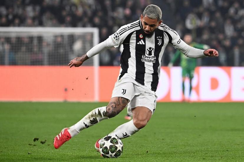 Juventus' Brazilian midfielder #26 Douglas Luiz kicks the ball during the UEFA Champions League knockout phase play-off 1st leg football match between Juventus and PSV Eindhoven at the Allianz stadium in Turin, on February 11, 2025.  Isabella BONOTTO / AFP