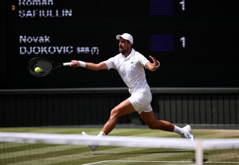 Serbia's Novak Djokovic returns to Russia's Roman Safiullin during their men's singles round of 16 tennis match on the seventh day of the 2026 Wimbledon Championships at The All England Lawn Tennis and Croquet Club in Wimbledon, southwest London, on July 5, 2026.  Henry Nicholls / AFP