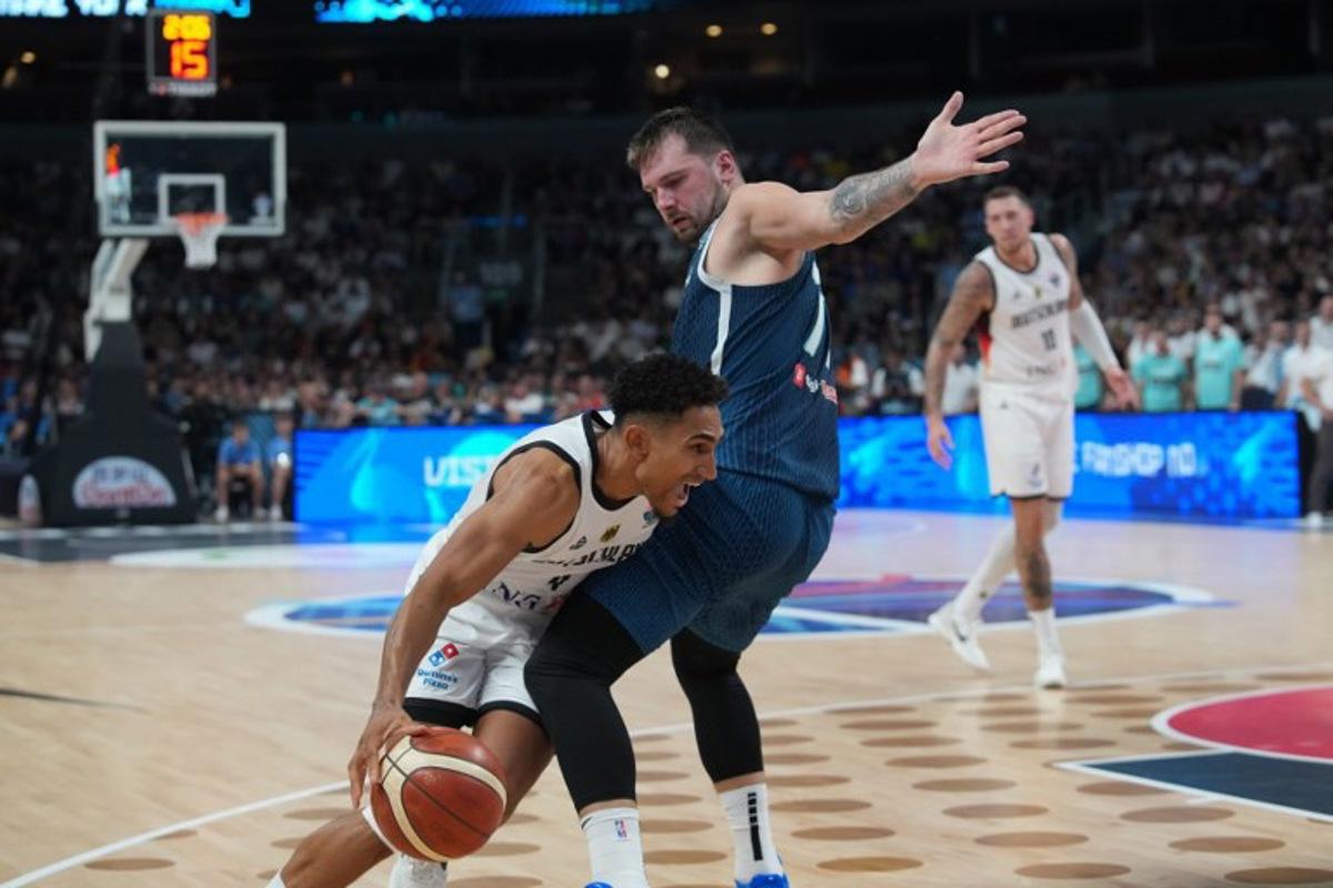 Germany's point guard #04 Maodo Lo and Slovenia's guard #77 Luka Doncic vie for the ball during the FIBA EuroBasket 2025 quarter-final basketball match between Germany and Slovenia in Riga, Latvia, on September 10, 2025.  Gints Ivuskans / AFP