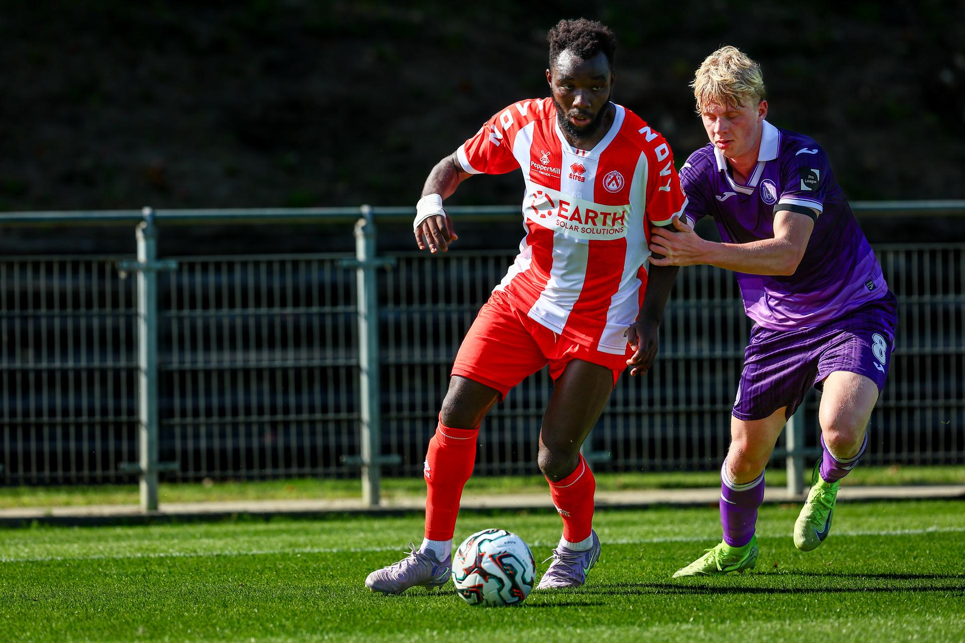 Kortrijk's Thierry Ambrose and RSCA Futures' Cedric Hatenboer fight for the ball during a soccer game between RSCA Futures and KV Kortrijk, Saturday 09 August 2025 in Deinze, on day 1 of the 2025-2026 'Challenger Pro League' 1B second division of the Belgian championship. BELGA PHOTO DAVID PINTENS