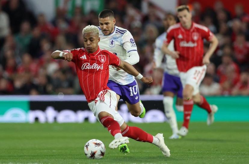 Aston Villa's Argentinian midfielder #10 Emiliano Buendia (C) chases Nottingham Forest's English midfielder #21 Omari Hutchinson during the UEFA Europa League semi-final first-leg football match between Nottingham Forest and Aston Villa at The City Ground in Nottingham, central England, on April 30, 2026.  Darren Staples / AFP