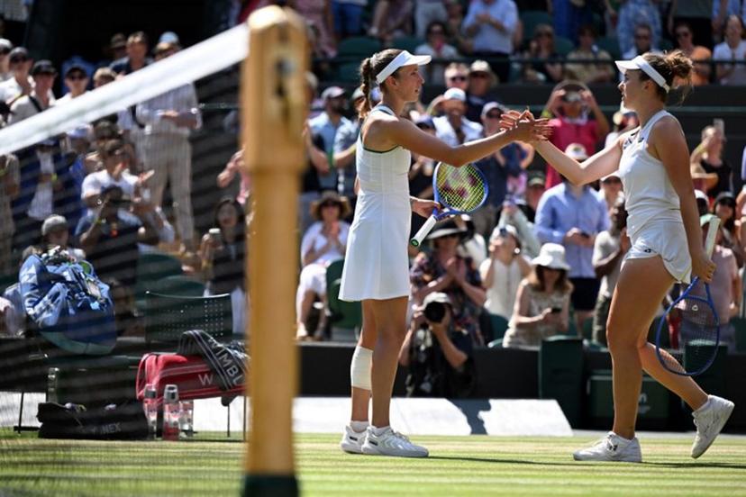 Czech Republic's Linda Noskova (R) is congratulated by Belgium's Elise Mertens for winning their women's singles quarter-final tennis match on the tenth day of the 2026 Wimbledon Championships at The All England Lawn Tennis and Croquet Club in Wimbledon, southwest London, on July 8, 2026.  Kirill KUDRYAVTSEV / AFP