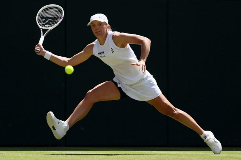 Poland's Iga Swiatek returns against Czech Republic's Karolina Pliskova during their women's singles second round tennis match on the fourth day of the 2026 Wimbledon Championships at The All England Lawn Tennis and Croquet Club in Wimbledon, southwest London, on July 2, 2026.  Adrian Dennis / AFP