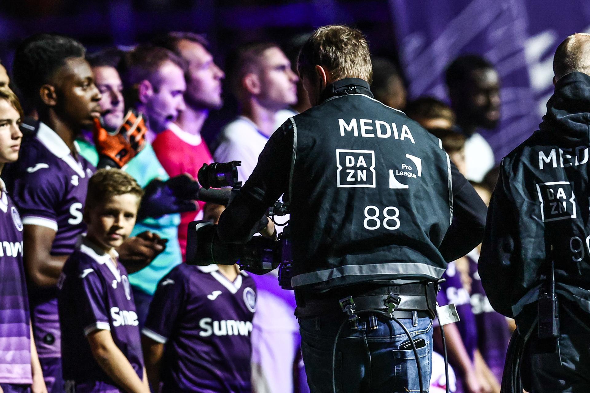 DAZN logo pictured at the start of a soccer match between RSC Anderlecht and KAA Gent, Tuesday 23 September 2025 in Anderlecht, a postponed game of day 5 of the 2025-2026 'Jupiler Pro League' first division of the Belgian championship. BELGA PHOTO BRUNO FAHY