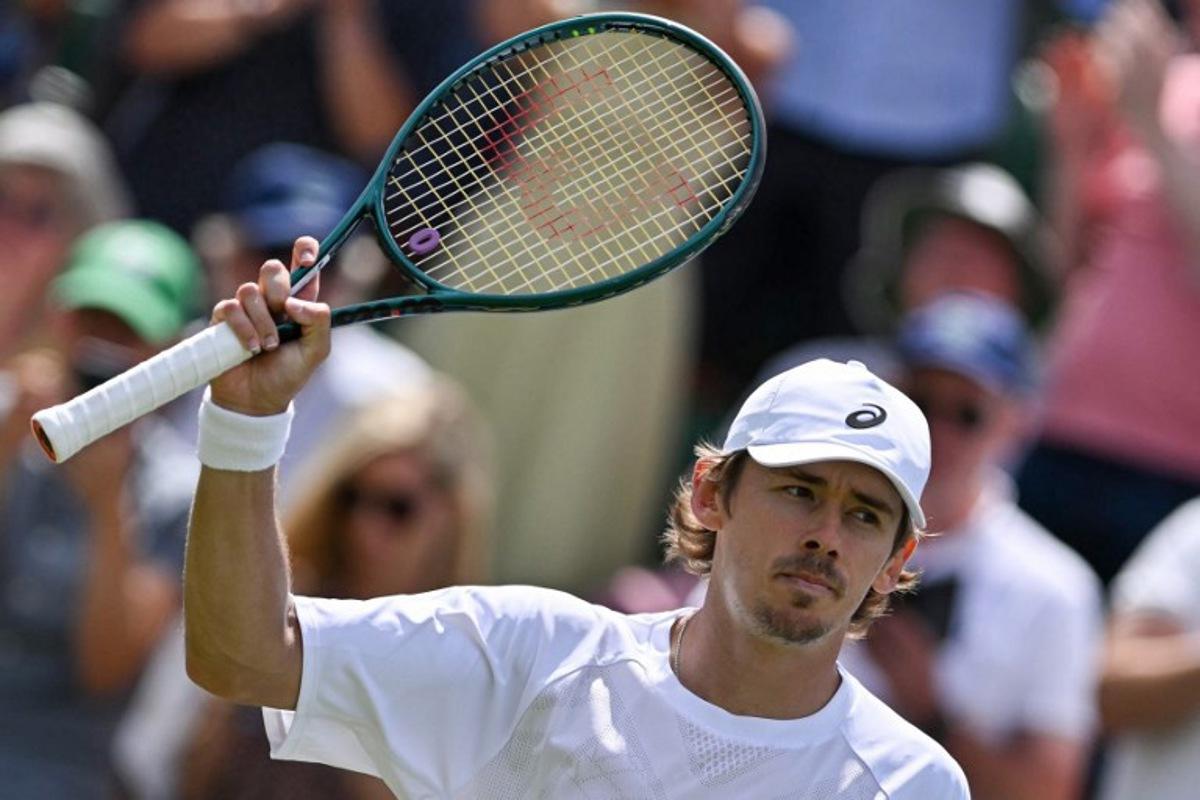Australia's Alex De Minaur celebrates after victory over France's Arthur Cazaux after their men's singles second round tennis match on the fourth day of the 2025 Wimbledon Championships at The All England Lawn Tennis and Croquet Club in Wimbledon, southwest London, on July 3, 2025.  Glyn KIRK / AFP