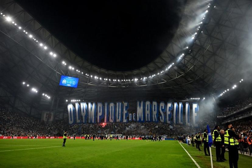 Marseille's supporters deploy a giant tifo after winning the French L1 football match between Olympique de Marseille (OM) and Paris Saint-Germain (PSG) at the Velodrome stadium in Marseille on September 22, 2025.  Miguel MEDINA / AFP