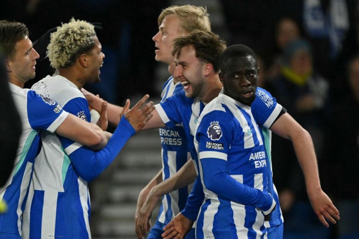 Brighton's English midfielder #13 Jack Hinshelwood (2R) celebrates with teammates after scoring their second goal during the English Premier League football match between Brighton and Hove Albion and Chelsea at the American Express Community Stadium in Brighton, southern England on April 21, 2026.  Glyn KIRK / AFP
