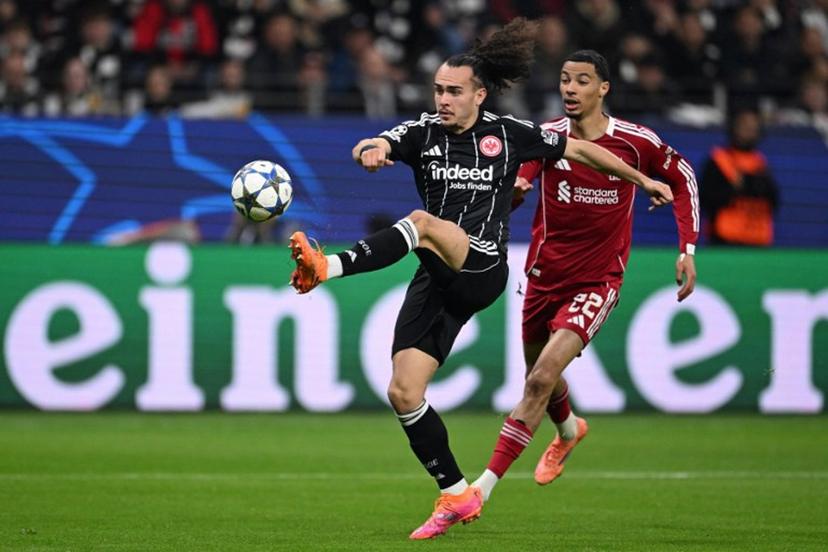 Frankfurt's Belgian defender #03 Arthur Theate (L) and Liverpool's French striker #22 Hugo Ekitike vie for the ball during the UEFA Champions League football match between Eintracht Frankfurt and Liverpool FC in Frankfurt, western Germany on October 22, 2025.  Kirill KUDRYAVTSEV / AFP