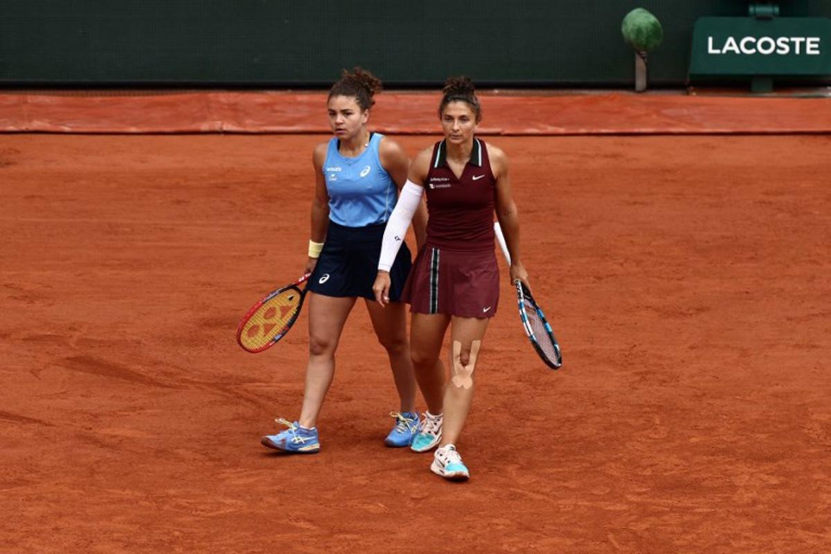 Italy's Jasmine Paolini (L) and Italy's Sara Errani react as they play against Kazakhstan's Anna Danilina and Serbia's Alexandra Krunic during their women's doubles final match on day 15 of the French Open tennis tournament on Court Philippe-Chatrier at the Roland-Garros Complex in Paris on June 8, 2025.  Thibaud MORITZ / AFP