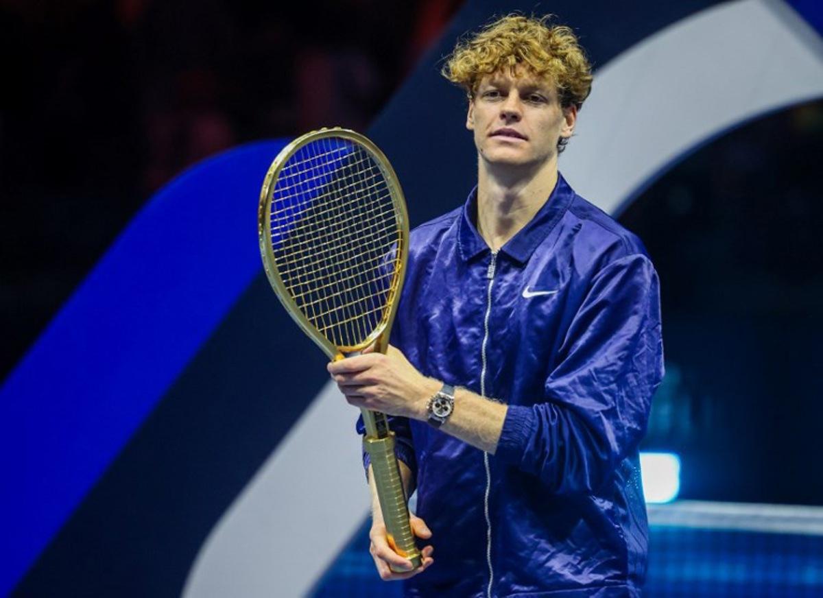 Italy's Jannik Sinner holds up his winning trophy, the Golden Racquet, after defeating Spain's Carlos Alcaraz in the final of the Six Kings Slam exhibition tennis tournament in Riyadh on October 18, 2025.  Fayez NURELDINE / AFP