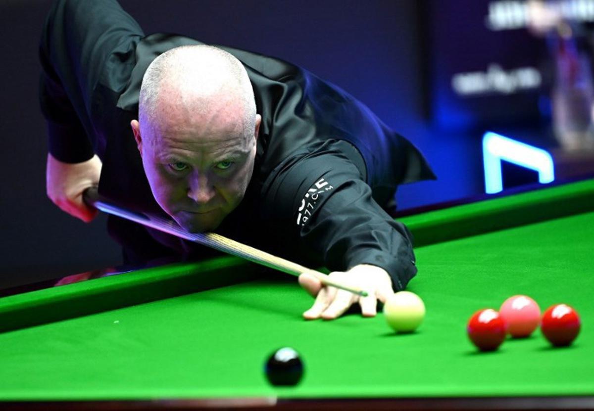 John Higgins of Scotland plays a shot during the first semi-final match against Marco Fu of Hong Kong at the Hong Kong Masters snooker tournament in Hong Kong on October 8, 2022.  Peter PARKS / AFP