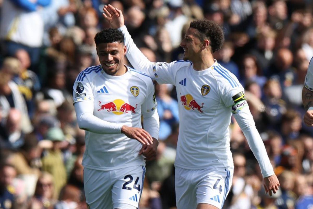 Leeds United's English defender #24 James Justin (L) celebrates with Leeds United's Welsh midfielder #04 Ethan Ampadu (R) after scoring the opening goal of the English Premier League football match between Leeds United and Wolverhampton Wanderers at Elland Road in Leeds, northern England on April 18, 2026.  Darren Staples / AFP