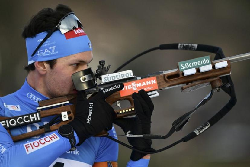 Italy's Tommaso Giacomel reacts as he competes during the men's 15km mass start event of the IBU Biathlon World Cup, in Le Grand Bornand, near Annecy, southeastern France, on December 21, 2025.  Olivier CHASSIGNOLE / AFP