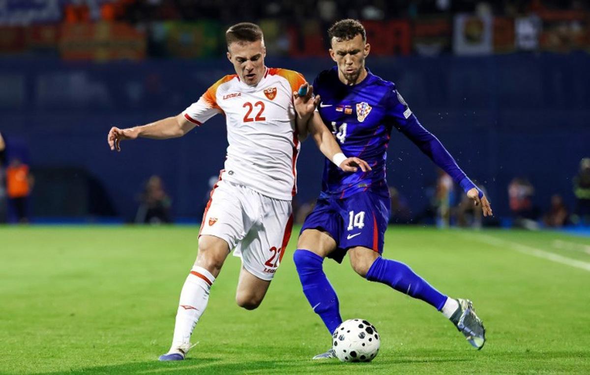 Croatia's forward #14 Ivan Perisic (R) fights for the ball with Montenegro's midfielder #22 Milan Roganovic #22 (L) during the FIFA World Cup 2026 Group L qualification football match between Croatia and Montenegro at the Maksimir Stadium in Zagreb, on September 8, 2025.  DAMIR SENCAR / AFP