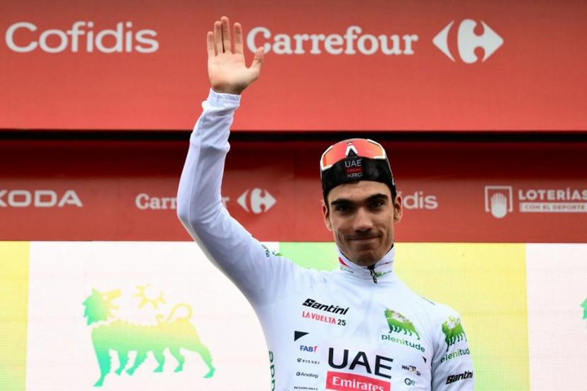 Team UAE's Spanish rider Juan Ayuso. wearing the best youth's white jersey, poses on the podium after  the second stage of the Vuelta a Espana, a 159,6 km race between Alba and Limone Piemonte, in Italy's Piemonte region, on August 24, 2025.    Marco BERTORELLO / AFP