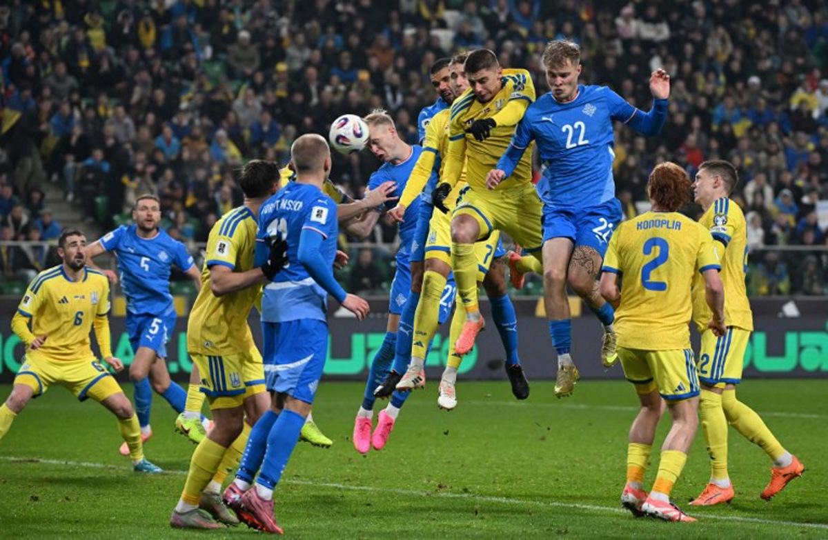 Iceland's defender #23 Hordur Magnusson (C L) heads the ball during the FIFA World Cup 2026 Group D European qualification football match betweem Ukraine and Iceland in Warsaw, Poland on Novmeber 16, 2025.   Sergei GAPON / AFP