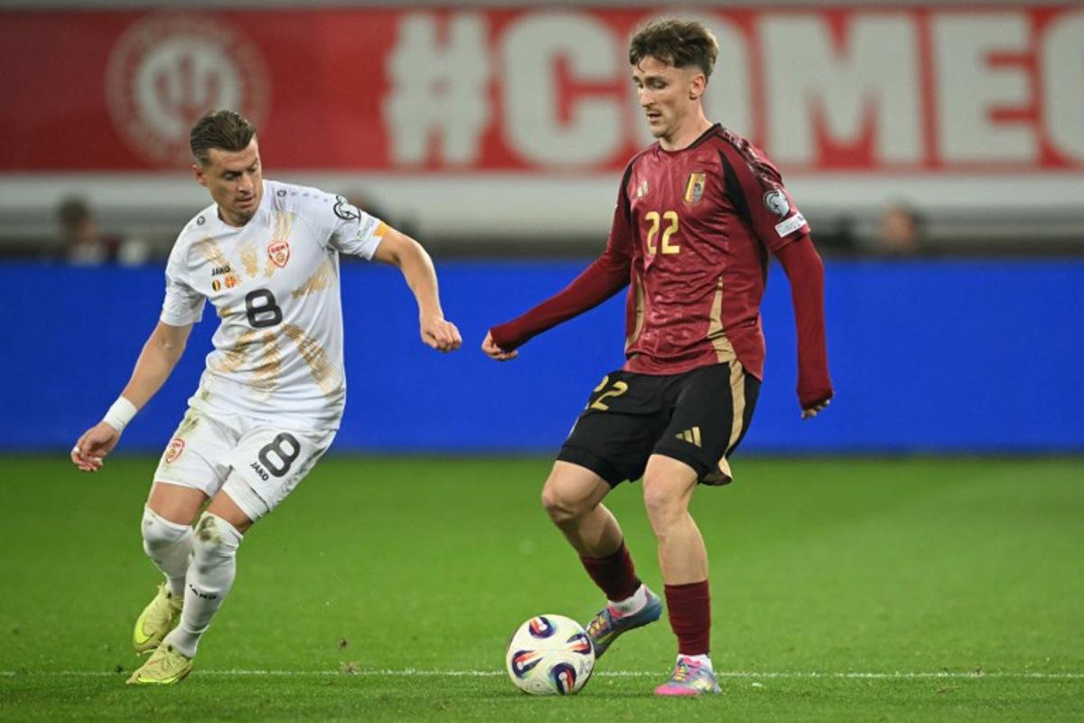 North Macedonia 's defender #08 Ezgjan Alioski (L) fights for the ball with Belgium's midfielder #22 Alexis Saelemaekers during the FIFA World Cup 2026 Group J European qualification football match between Belgium and North Macedonia at the Planet Group Arena in Ghent, on October 10, 2025.  NICOLAS TUCAT / AFP