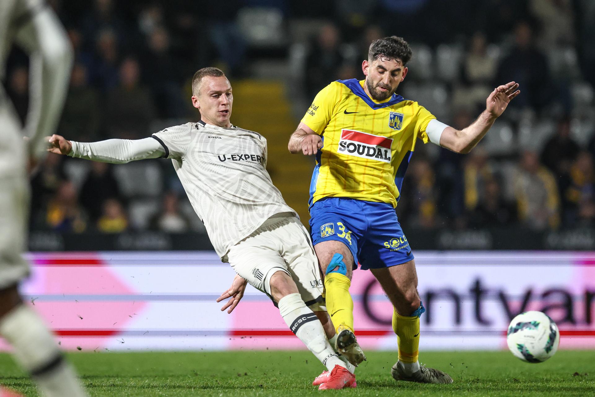 Charleroi's Nikola Stulic and Westerlo's Dogucan Haspolat fight for the ball during a soccer match between KVC Westerlo and Sporting Charleroi, Friday 11 April 2025 in Westerlo, on day 3 (out of 10) of the Europe Play-offs of the 2024-2025 'Jupiler Pro League' first division of the Belgian championship. BELGA PHOTO BRUNO FAHY