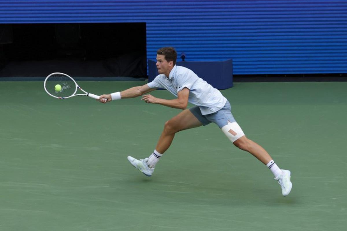 Belgium's Alexander Blockx hits a return to Argentina's Francisco Cerundolo in their men's singles round of 16 tennis match on day nine of the US Open tennis tournament at the USTA Billie Jean King National Tennis Center in New York on September 7, 2026.  KENA BETANCUR / AFP