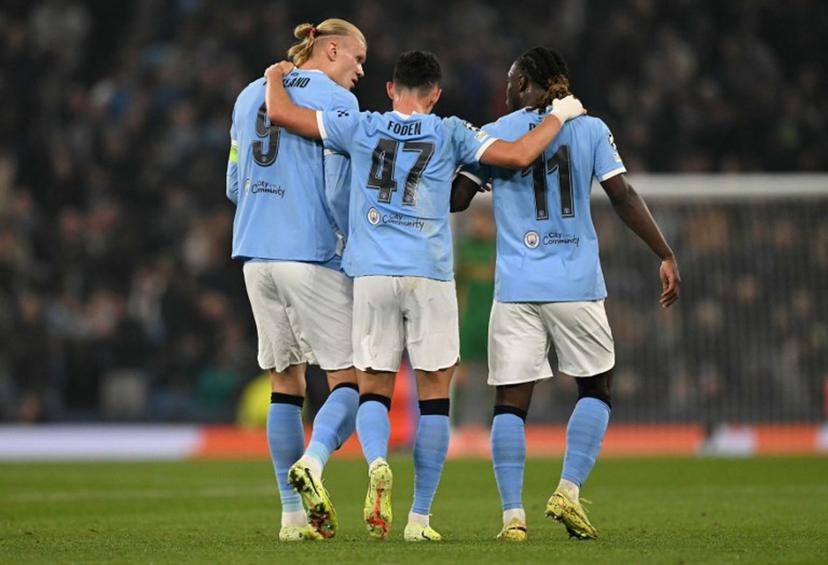 Manchester City's Norwegian striker #09 Erling Haaland (L) celebrates scoring his team's second goal with Manchester City's English midfielder #47 Phil Foden (C) and Manchester City's Belgian midfielder #11 Jeremy Doku during the UEFA Champions League football match between Manchester City and Borussia Dortmund at the Etihad Stadium in Manchester, north west England, on November 5, 2025.  Oli SCARFF / AFP