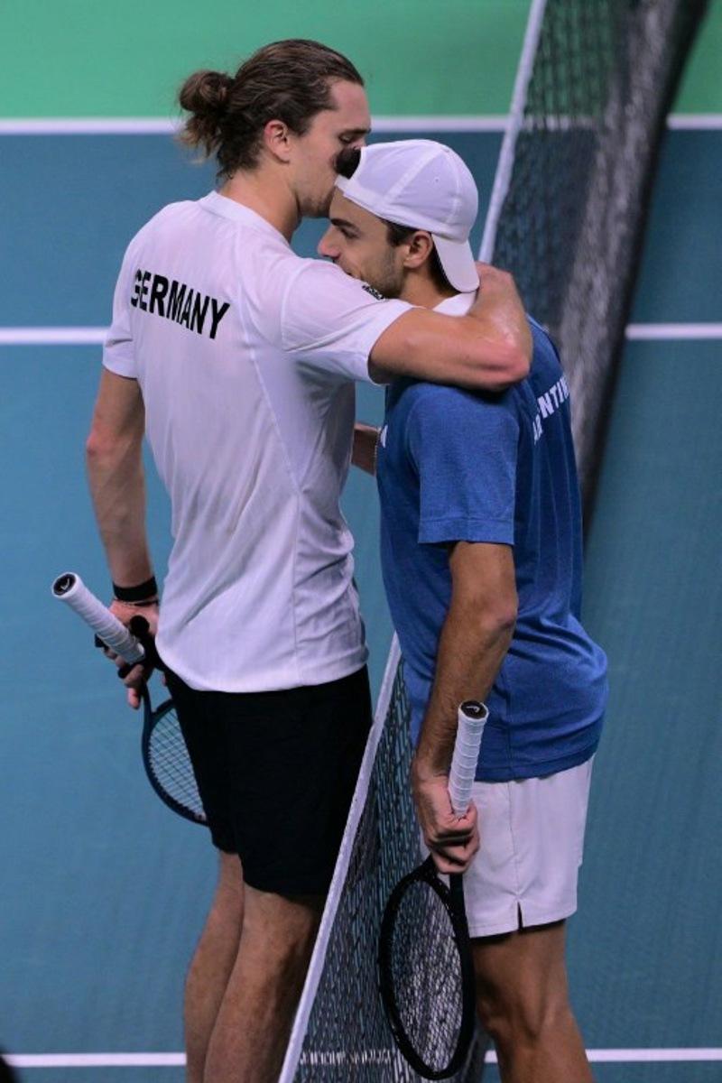Germany's Alexander Zverev (L) and Argentina's Francisco Cerundolo embrace at the end of their match during the Davis Cup men's singles quarter finals tennis match, at the Super Tennis Arena, in Bologna, northen Italy, on November 20, 2025.  Tiziana FABI / AFP